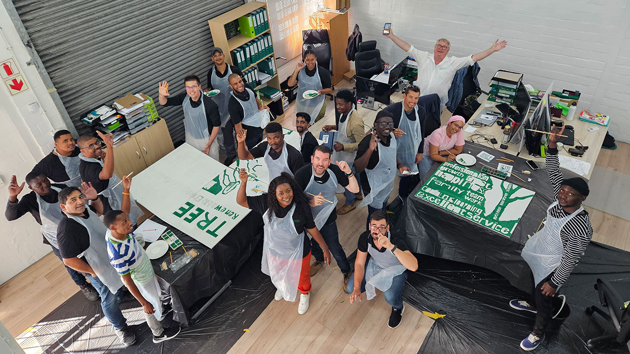 Treetops staff painting banners as a team building exercise